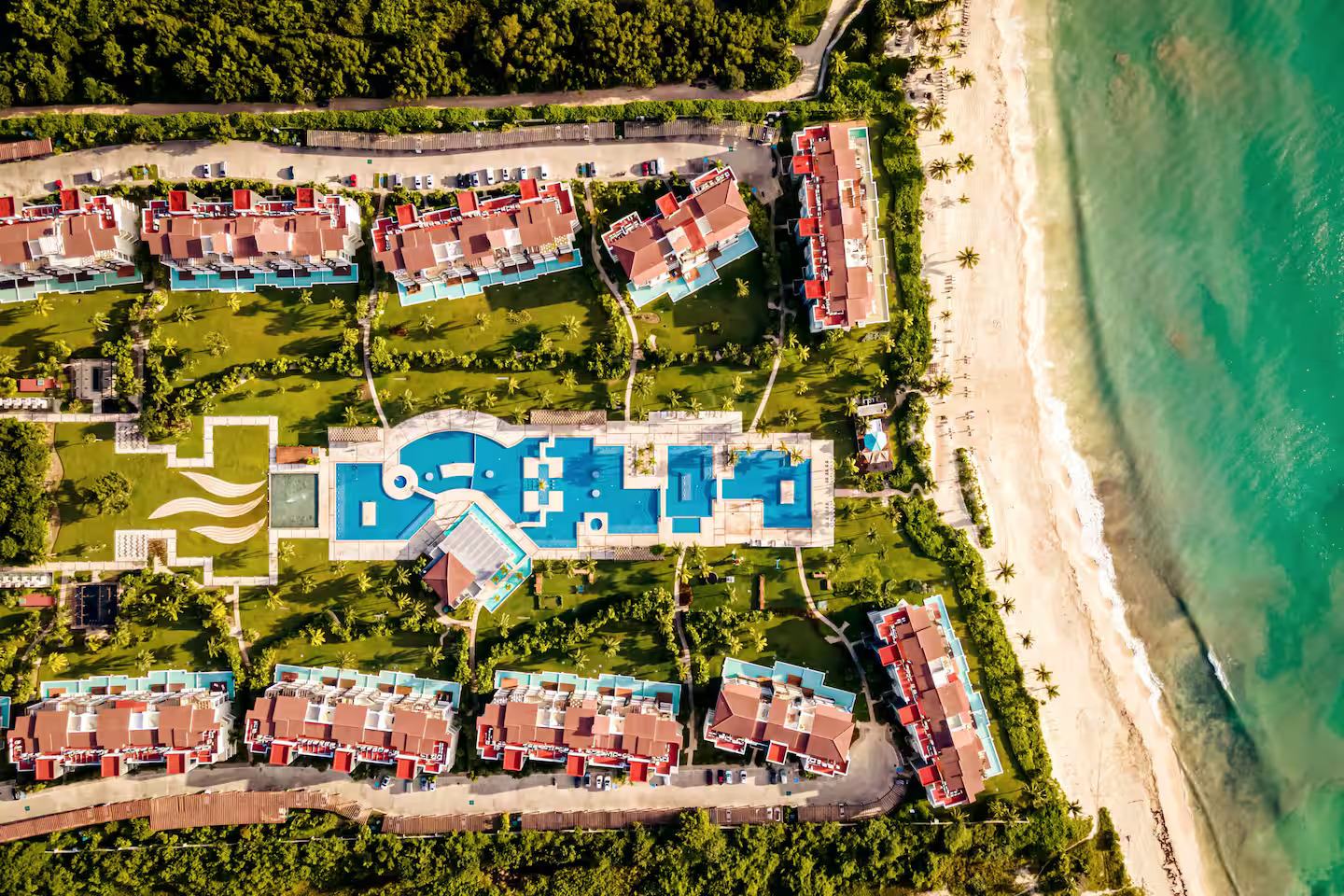 Top-down aerial view of Mareazul's pool, gardens and beach